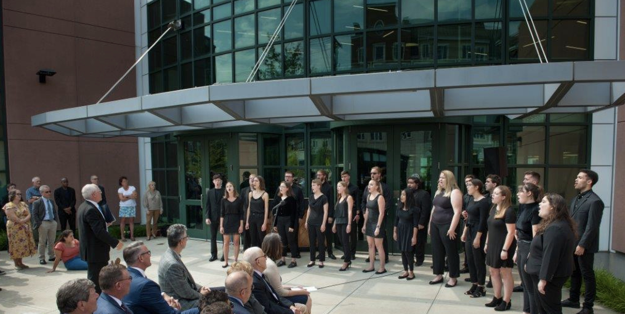 Students singing at the dedication of the Zachs Arrs Administration Building at UConn