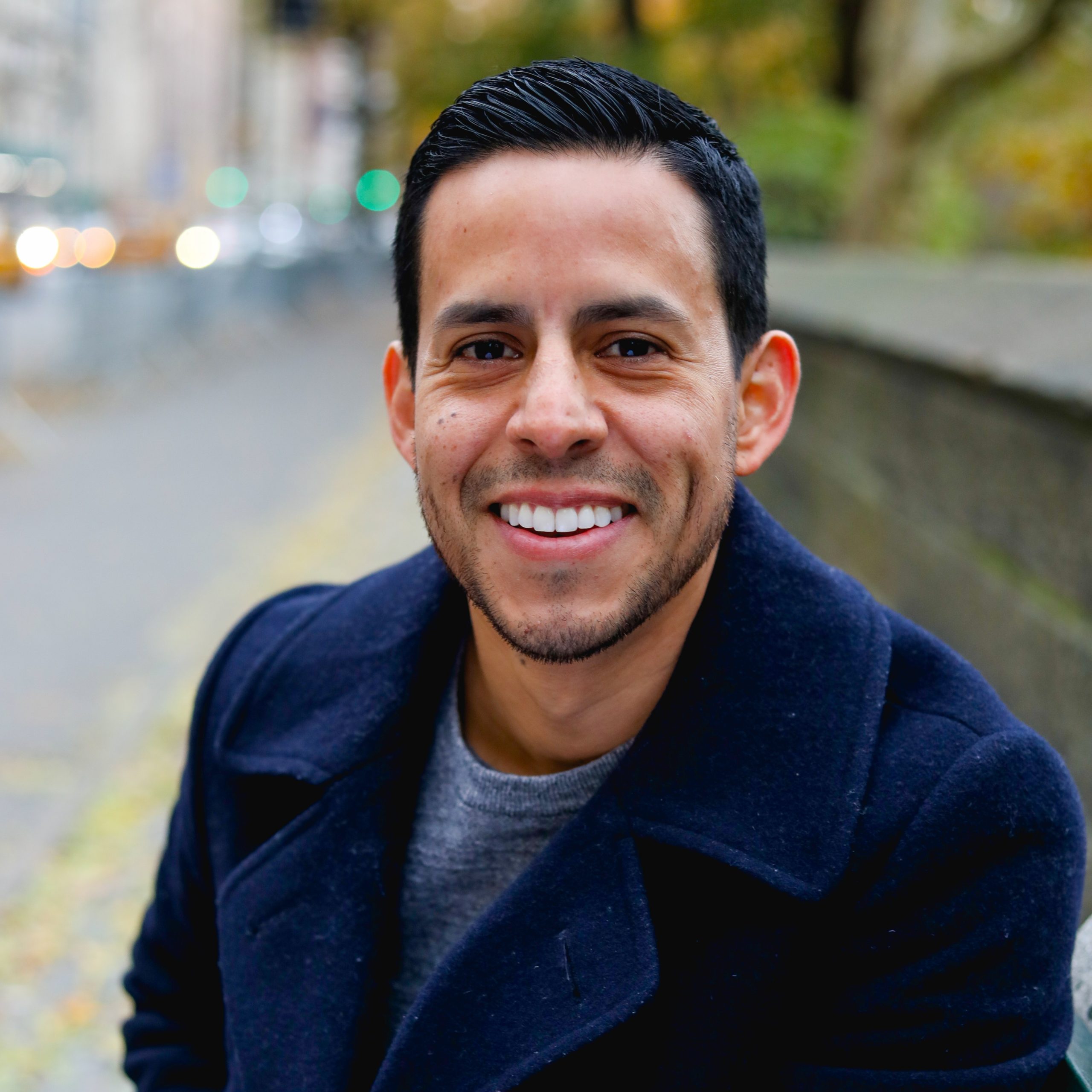Man smiling, black slick hair
