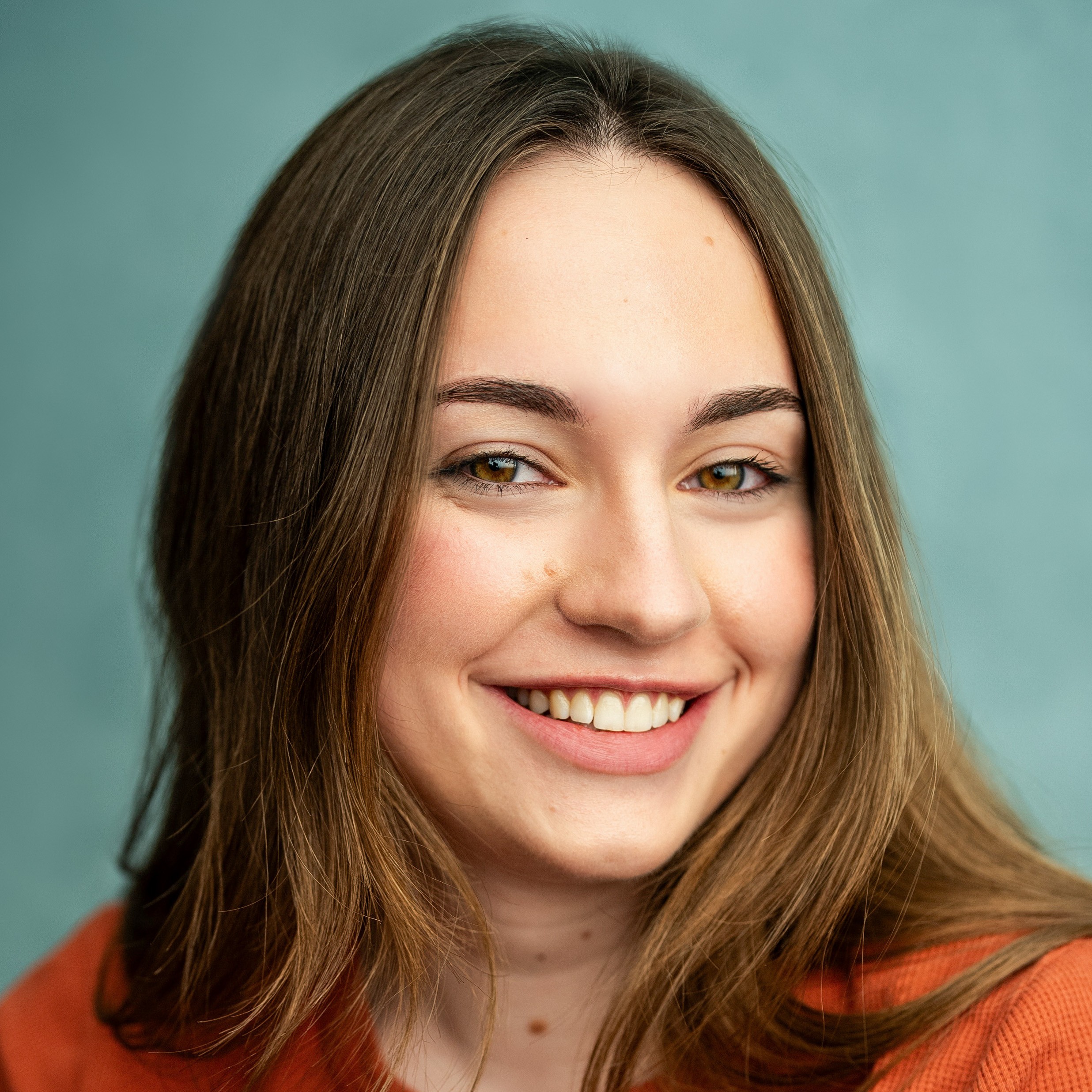 Smiling white woman, green background